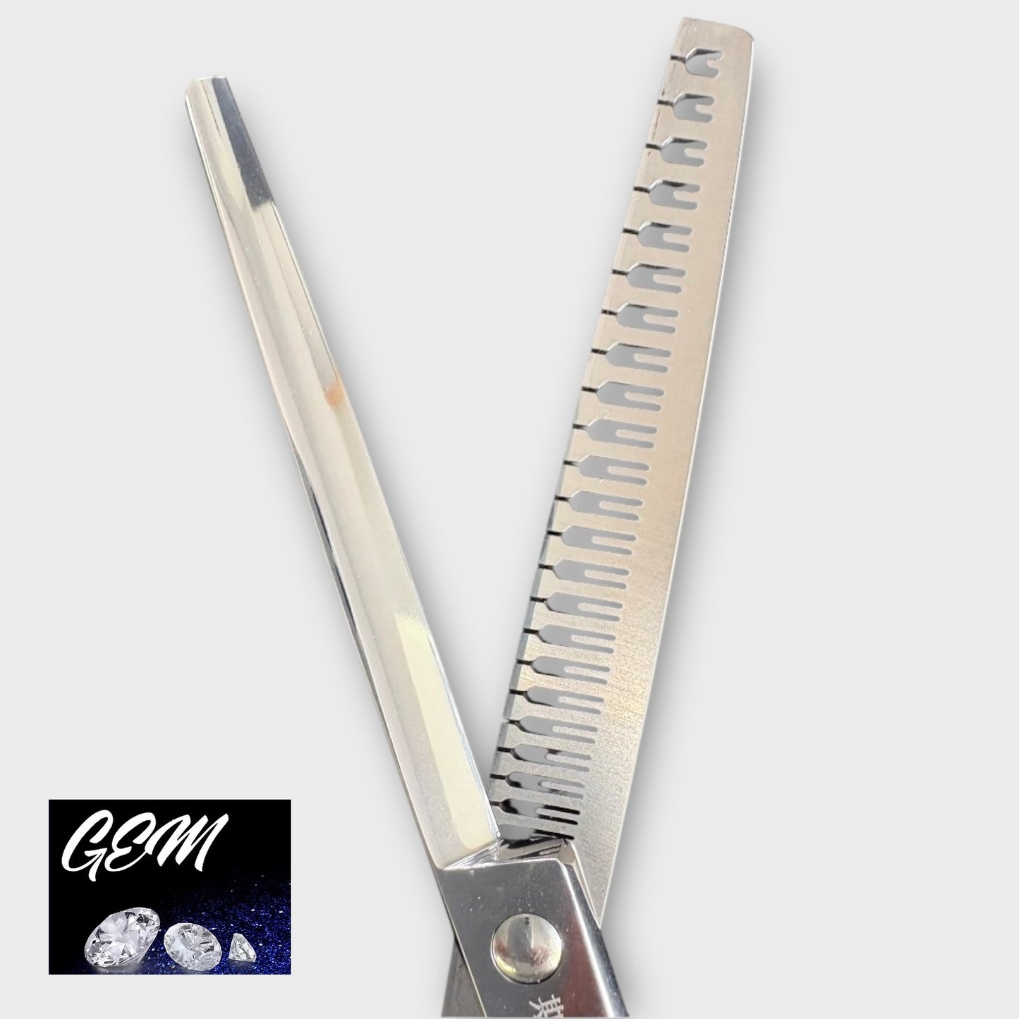 A close-up of GEM Supreme Straight Eraser 7" Scissors, featuring one serrated and one straight blade. The corner displays the GEM logo with three diamonds on a dark blue background, emphasizing professional grooming tools.
