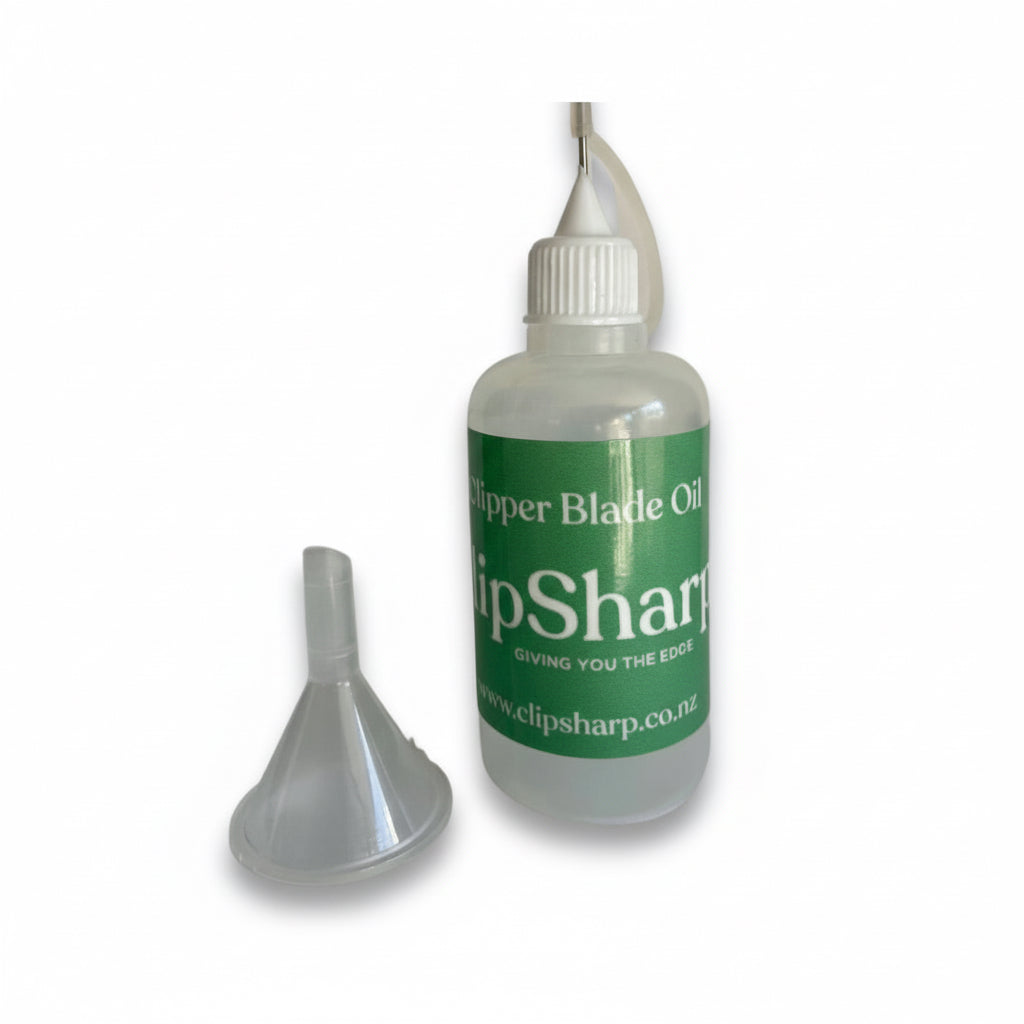 A Dispensing Bottle for Clipper/Scissor oil with a green label is shown beside a small plastic funnel on a white background.