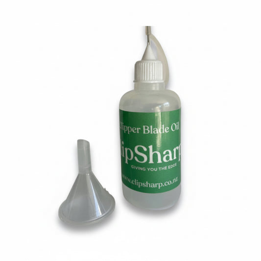 A Dispensing Bottle for Clipper/Scissor oil with a green label is shown beside a small plastic funnel on a white background.