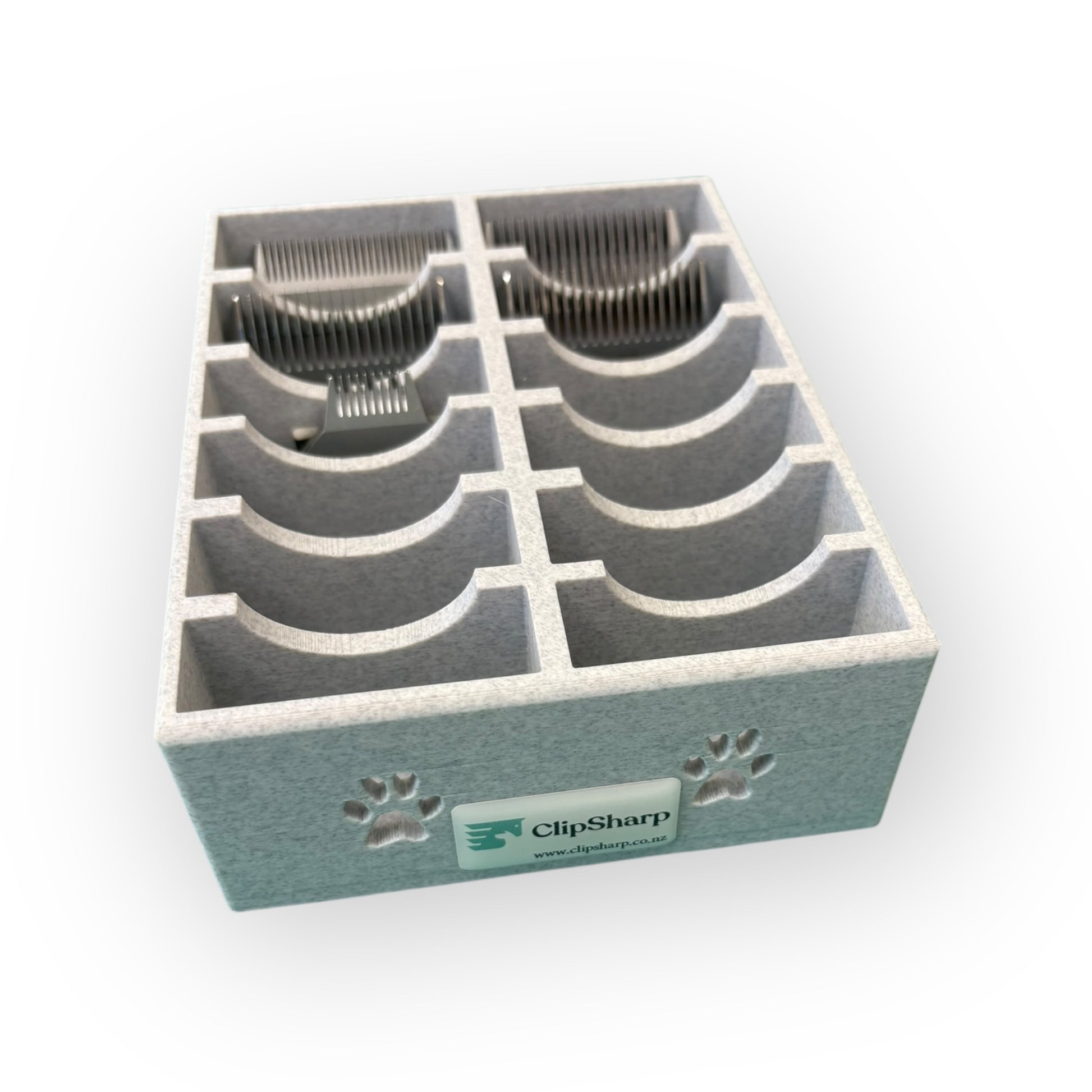 The Clip Sharp Standard Blade Tray is a gray 3D-printed organizer with eight curved slots for metal clipper blades, featuring the ClipSharp logo and two paw prints on the front.
