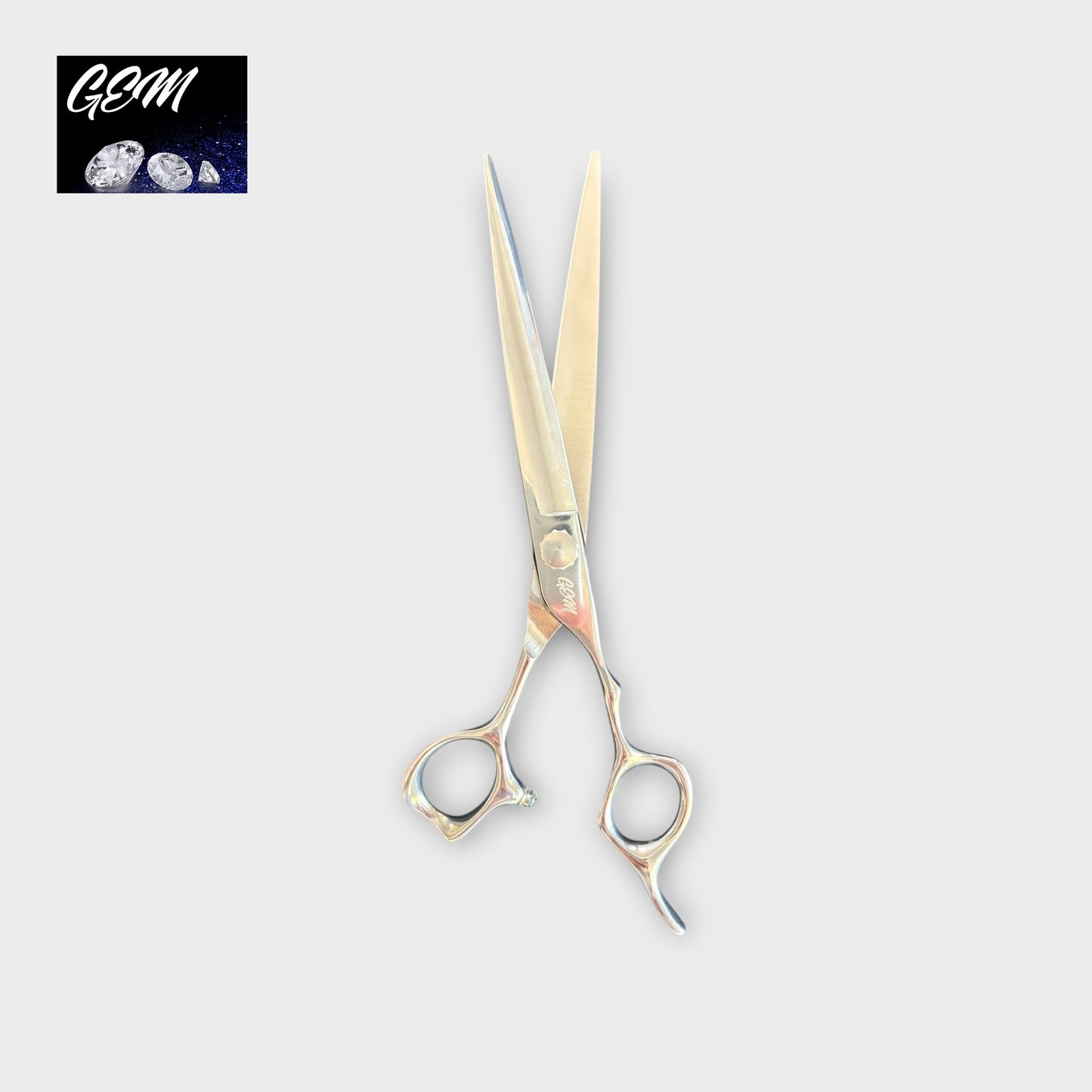 The GEM Supreme Straights 7.5" Scissors, featuring finger rests and a shiny finish, are displayed on a light gray background. A logo with "GEM" and three gemstones appears in the top left corner.